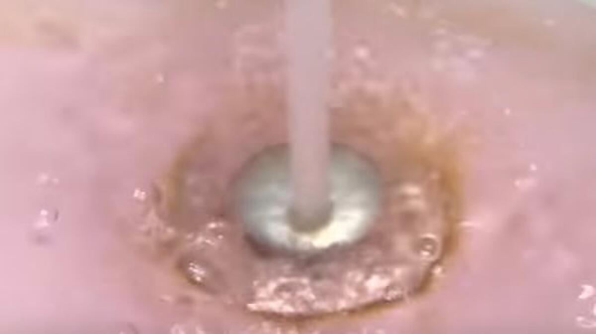 In this screen shot from a report on CTV, the pink water that flowed out of taps in Onoway, Canada is seen.