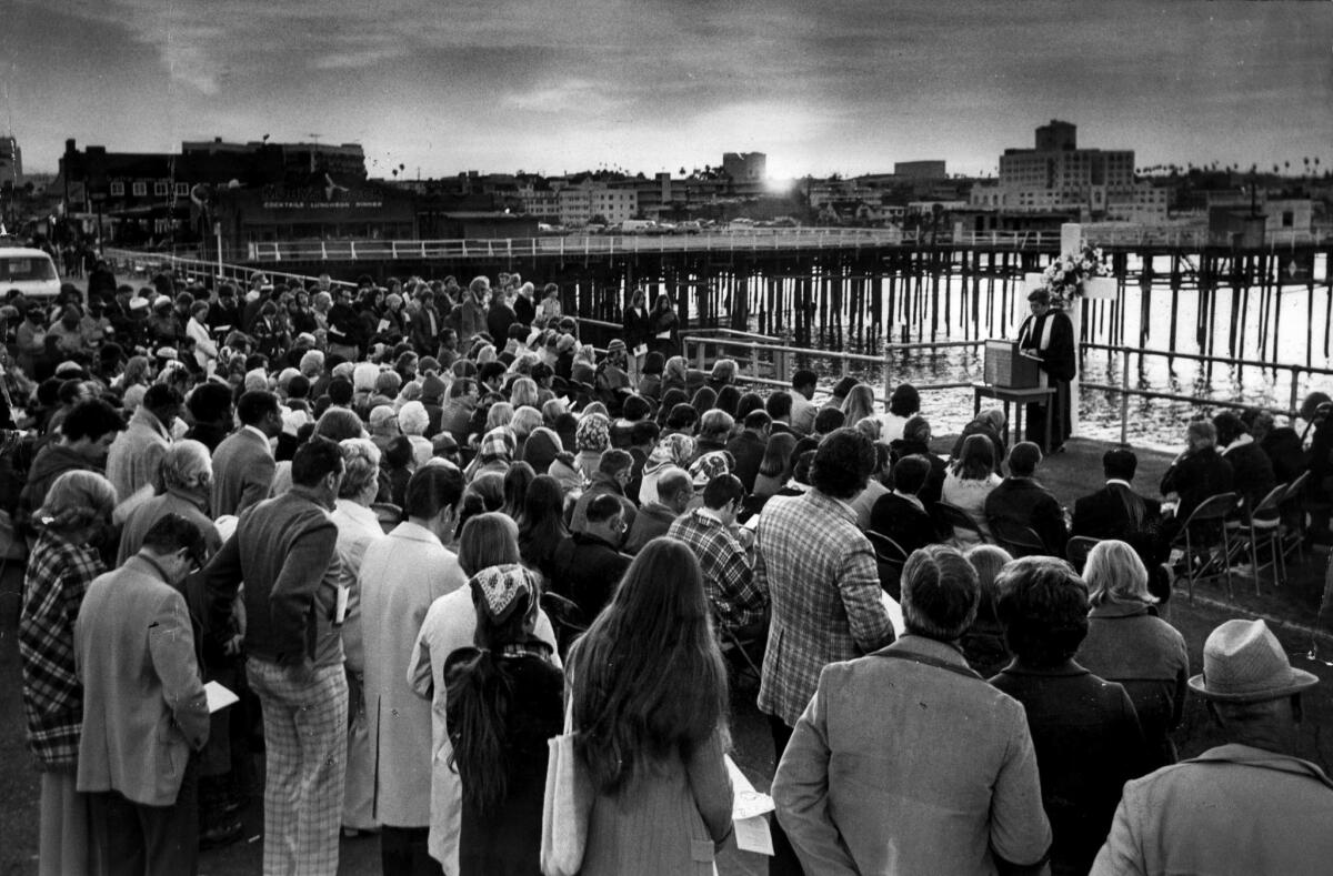 April 18, 1976: The Rev. Joseph E. Parshall leads prayer with hundreds gathered on Santa Monica pier for Easter Sunrise Service.