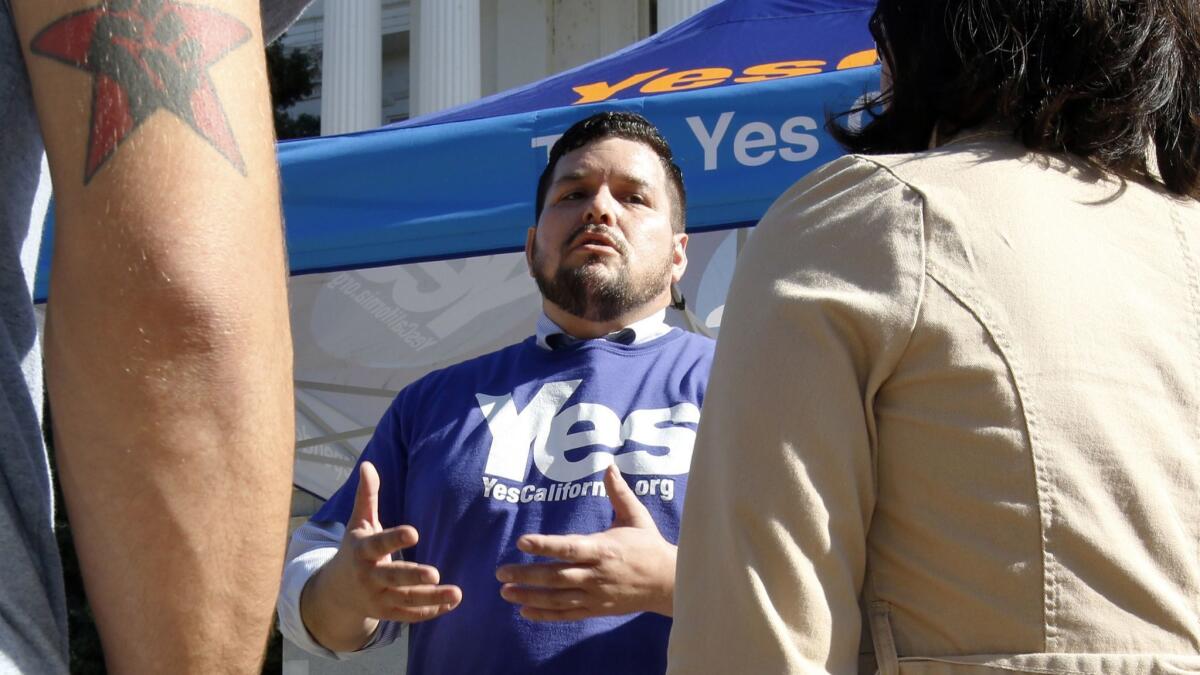 Marcus Ruiz Evans, center, of the Yes California Independence Campaign talks in Sacramento in 2017 about California seceding from the United States and becoming its own nation.