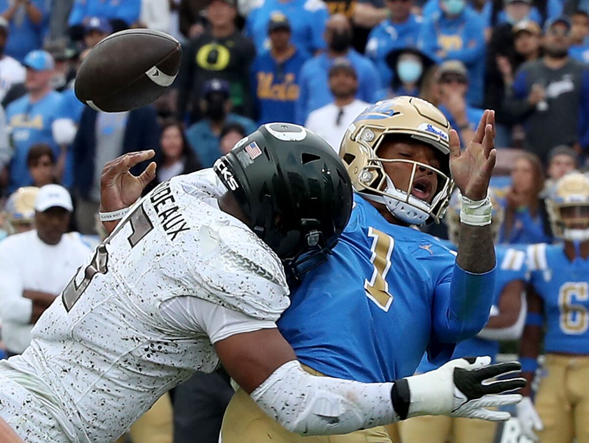 UCLA quarterback Dorian Thompson-Robinson loses control of the ball as he is sacked by Oregon linebacker Kayvon Thibodeaux.