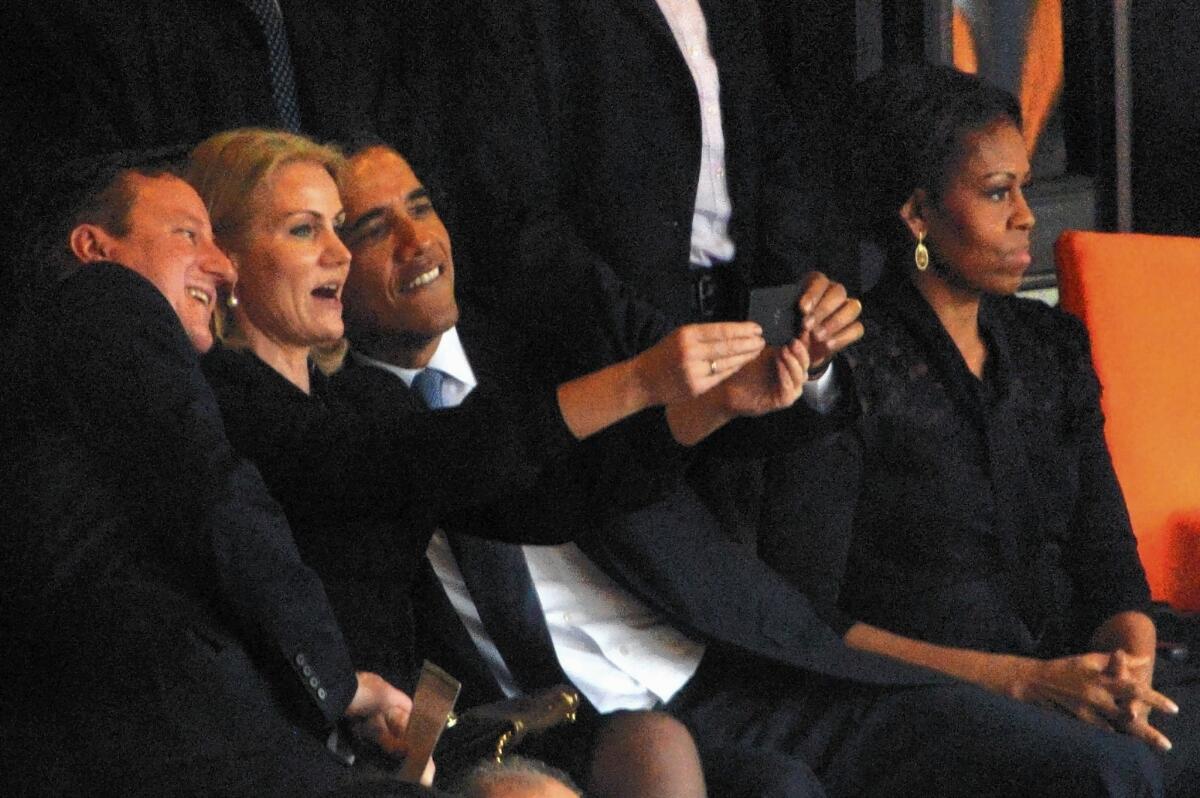 President Obama and British Prime Minister David Cameron pose for a picture with Denmark's Prime Minister Helle Thorning Schmidt during the memorial service of Nelson Mandela in South Africa on Tuesday.