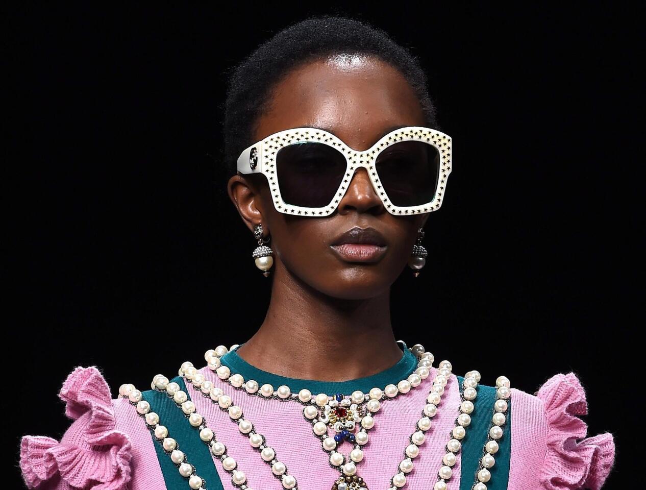 Big statement sunglasses, grandma-chic pearls and pops of color mark the fall/winter looks from Gucci.