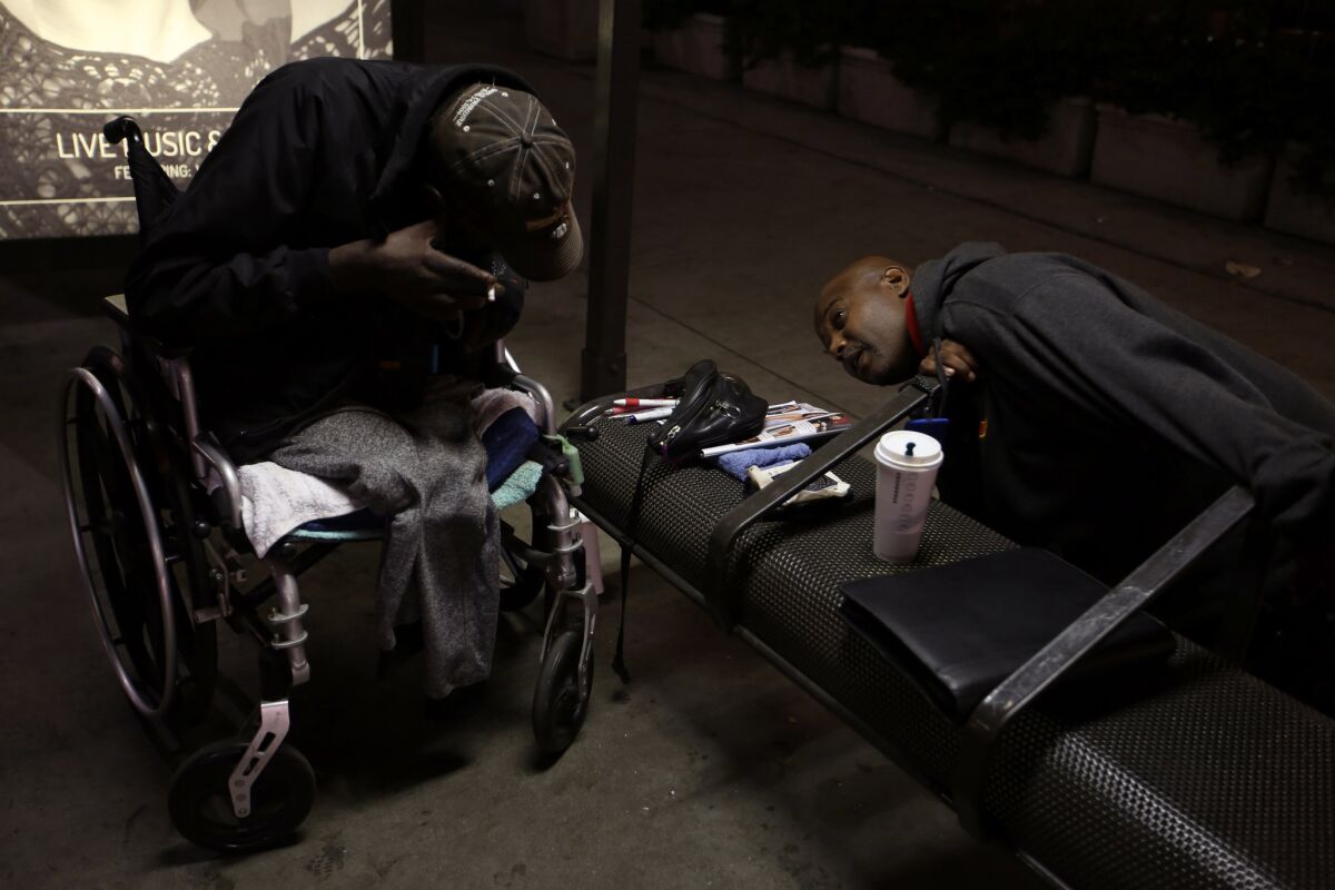 At 4:30 am Ruffin finds Eddie "Snake" Carter, 65, in pain, sheltering under a bus stop. (Francine Orr / Los Angeles Times)