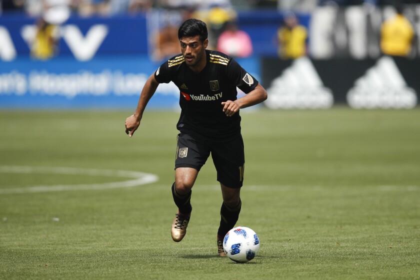 Los Angeles FC's Carlos Vela dribbles the ball during the first half of an MLS soccer match against the Los Angeles Galaxy Saturday, March 31, 2018, in Carson, Calif.