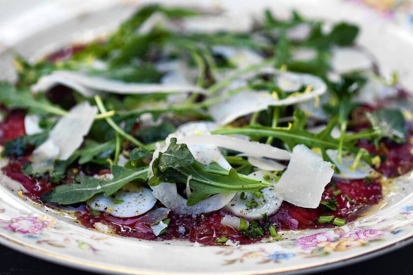 Venison carpaccio is served with fennel, arugula and sheep cheese atop a bed of horseradish creme fraiche at The Hart & The Hunter.