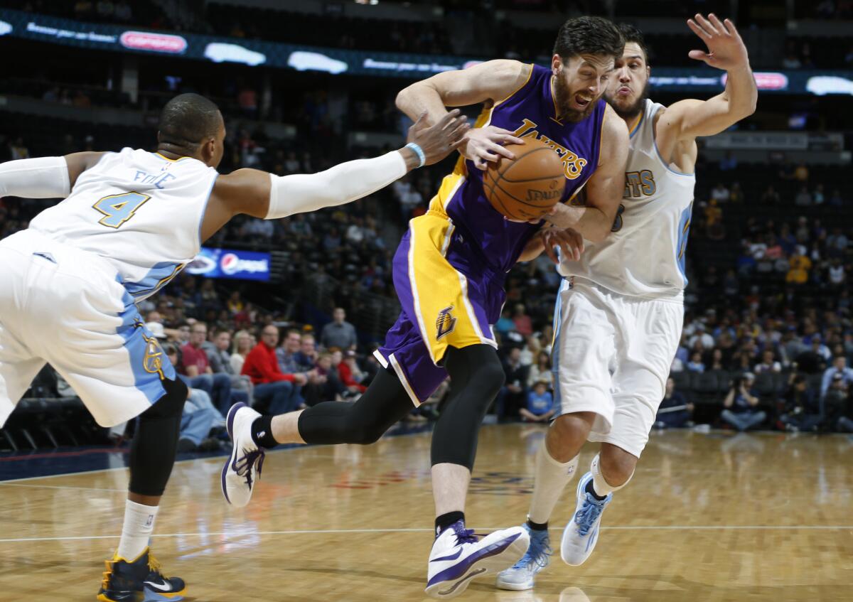 Laker Ryan Kelly, center, tries to get past Denver's Danilo Gallinari, right. The Lakers will play the Sacramento Kings on Monday night.