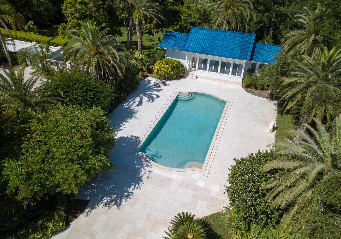 An aerial view of the swimming pool and pool house.