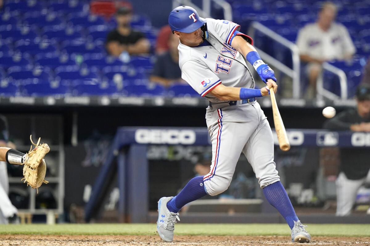 Texas Rangers' Josh Jung hits a RBI double to score Adolis Garcia during the seventh inning of a baseball game against the Miami Marlins, Monday, Sept. 12, 2022, in Miami. The Rangers won 3-2. (AP Photo/Lynne Sladky)