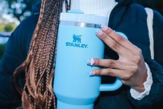 Los Angeles, CA - January 08:Kimora Johnson poses for a portrait with a Stanley Cup branded water bottle outside Alexander Hamilton Senior High School where she attends school on Monday, Jan. 8, 2024 in Los Angeles, CA. Johnson purchased the cup recently from Urban Outfitters. (Dania Maxwell / Los Angeles Times)