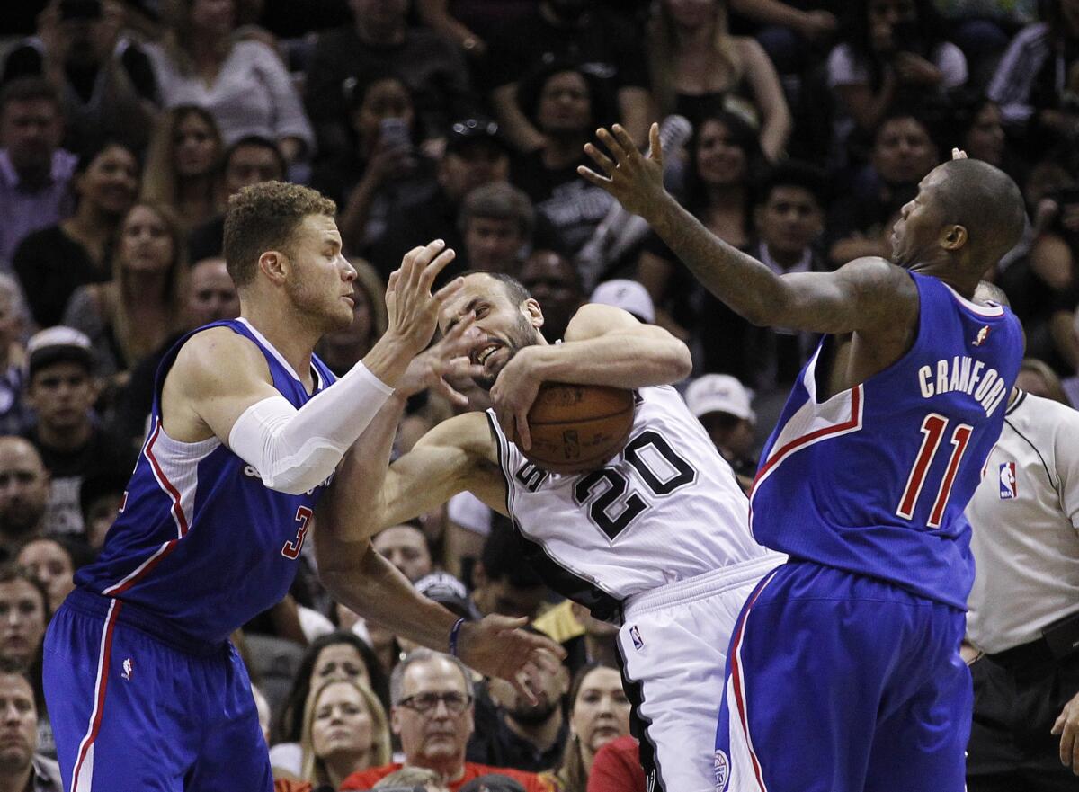 Spurs guard Manu Ginobili fights to keep control of the ball as he is swarmed by Clippers power forward Blake Griffin and guard Jamal Crawford.
