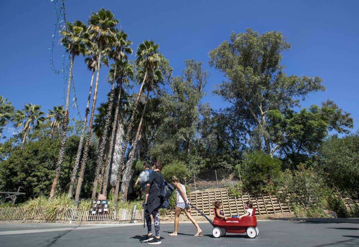 Visitors walk past an area of the Los Angeles Zoo slated for redevelopment. 