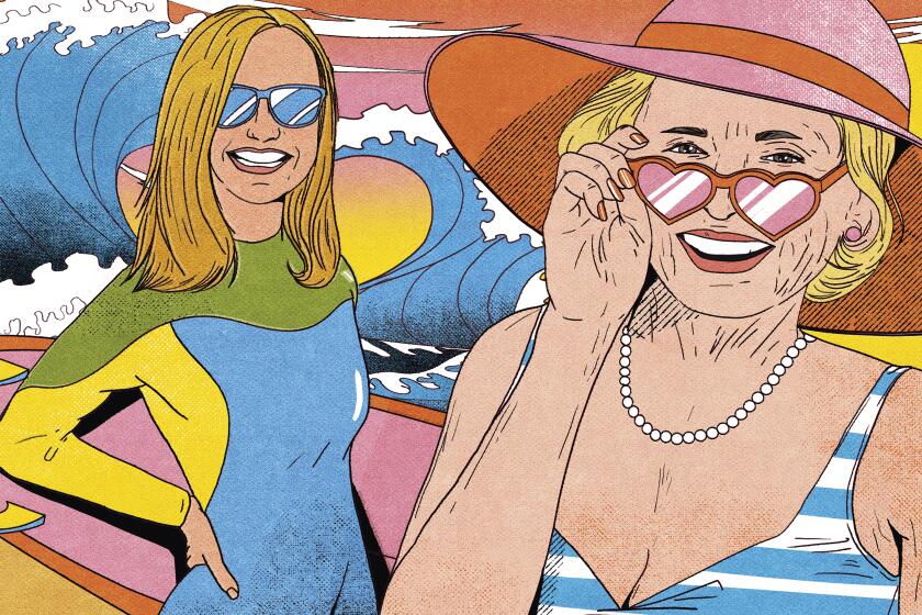 Two women at the beach, one wearing heart-shaped sunglasses.