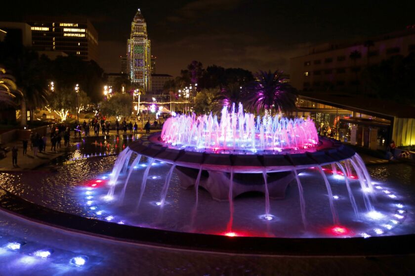 With a gleaming City Hall in the background, the fountain glows as revelers greet the new year in Grand Park downtown.