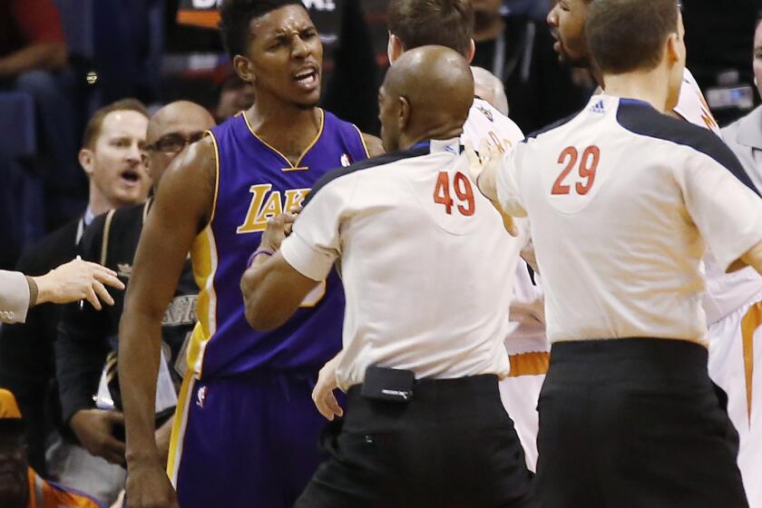 Lakers small forward Nick Young is separated from Phoenix Suns guard Goran Dragic during a first-half scuffle on Wednesday. Young and Phoenix center Alex Len were ejected from the game.