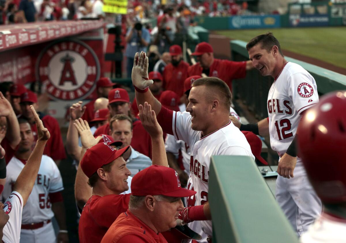 Angels outfielder Mike Trout, center, celebrates hitting his 33rd home run of the year in the first inning against the Orioles on his 24th birthday.