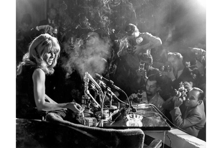 April 19, 1966: Julie Christie meets a throng of photographers and reporters at the Beverly Hills Hotel the morning after winning her Best Actress Oscar for "Darling."