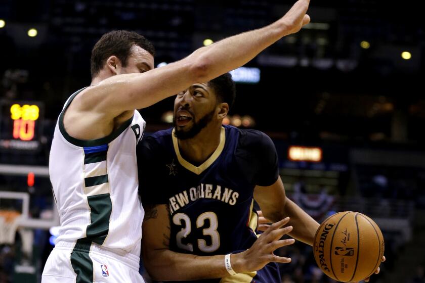 Pelicans forward Anthony Davis tries to drive past Bucks center Mile Plumlee in the first half Thursday night.