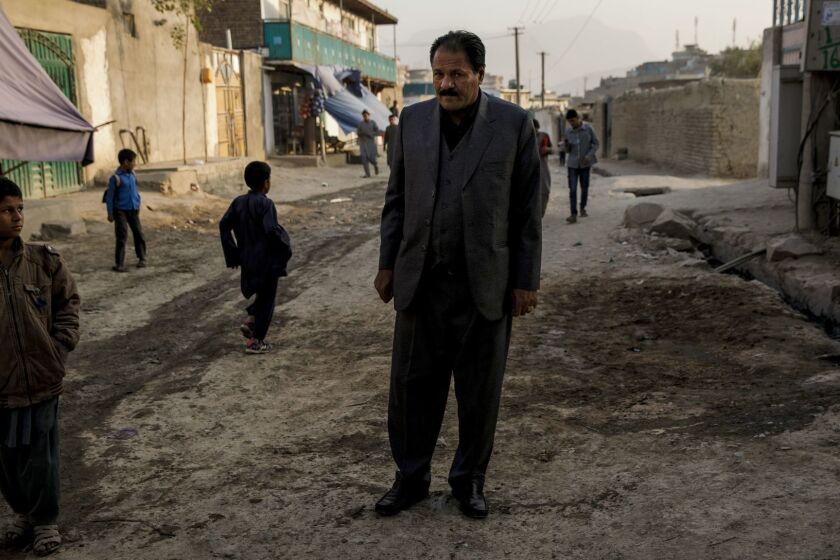 KABUL, KABUL PROVINCE -- WEDNESDAY, NOVEMBER 1, 2017: police Col. Haji Habib Rahman, father of the slain Almar Habibzai, stands over the site where his son was killed outside their home in Kabul, Afghanistan, on Nov. 1, 2017. There are few more dangerous places in the world to be a law enforcement officer than Afghanistan. Even after 16 years of U.S.-backed efforts to battle organized crime and install the rule of law, corruption remains a national epidemic â and almost anyone who fights it a target. On the cool mid-October evening that Habibzai was shot, he had not yet completed one year as an officer with Afghanistanâs Major Crimes Task Force, a police agency the Pentagon established in 2009 with the goal of creating what U.S. officials called âthe Afghan FBI.â Its investigators have been trained and supplied by Americans â first FBI agents and now civilian contractors overseen by the U.S.-led NATO mission in Kabul. (Marcus Yam / Los Angeles Times)