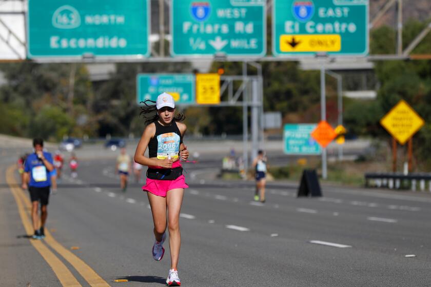 SAN DIEGO, CA - OCTOBER 24: Runners in the marathon portion of the Rock 'n' Roll Marathon and Half run on State Route 163 in Mission Valley on Sunday Oct. 24, 2021. (K.C. Alfred / The San Diego Union-Tribune)