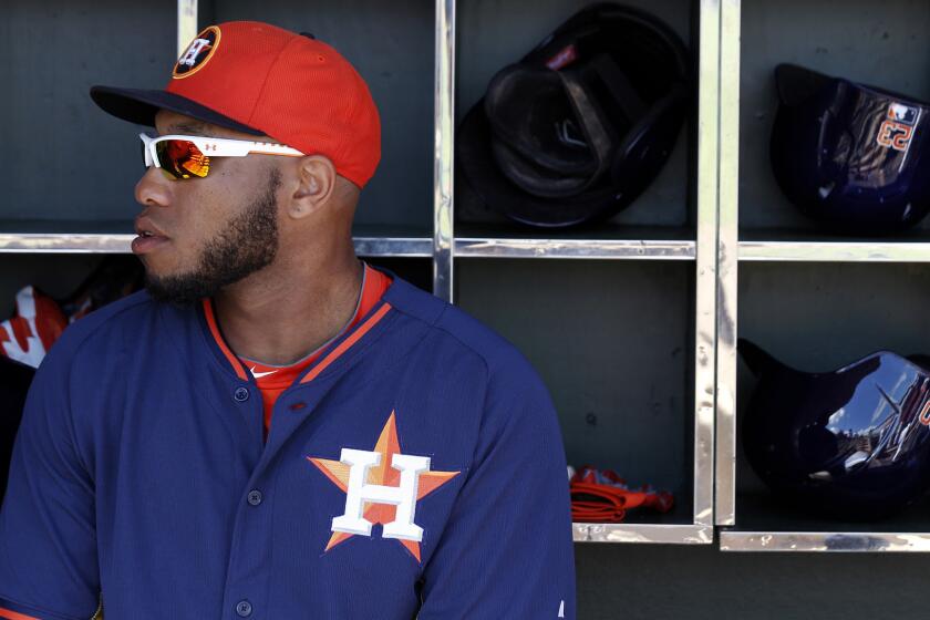 Houston Astros first baseman Jon Singleton sits in the dugout before a spring training game against the Atlanta Braves on March 2. Singleton is set to make his major league debut against the Angels on Tuesday.