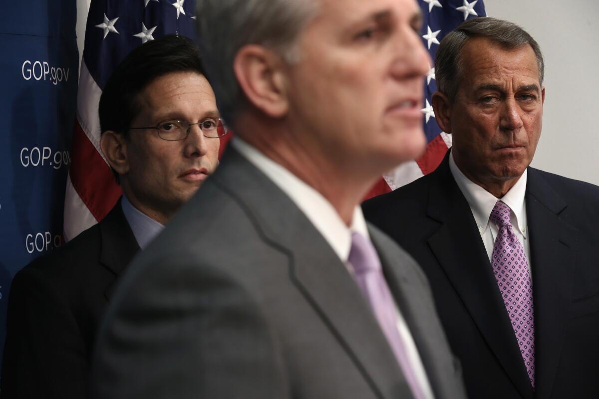 House Majority Whip Rep. Kevin McCarthy (R-Calif.), center, speaks as Speaker John A. Boehner (R-Ohio), right, and Majority Leader Eric Cantor (R-Va.) listen during a news briefing on Jan. 14 in Washington.
