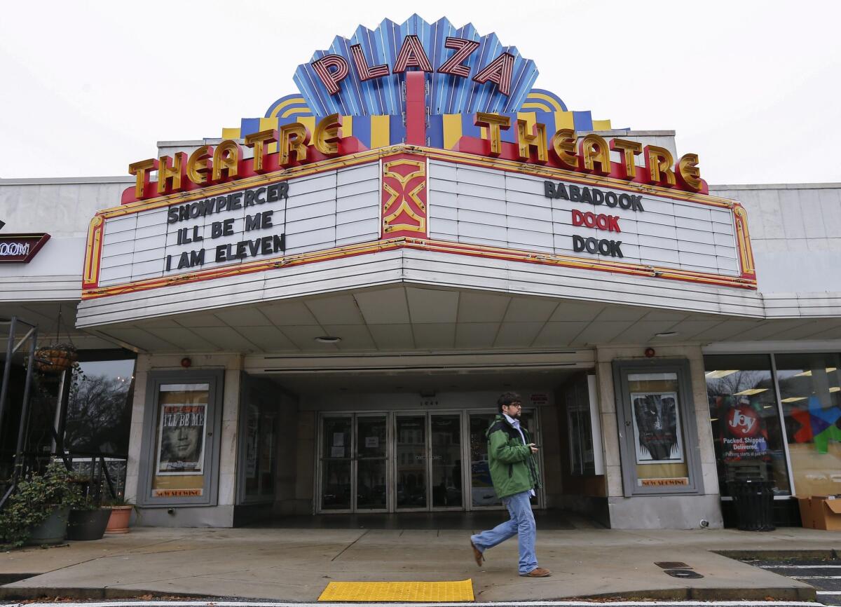 A man walks past the Plaza Theatre in Atlanta after the cinema announced via its Twitter account Tuesday that it would start showing the movie "The Interview" on Christmas Day.