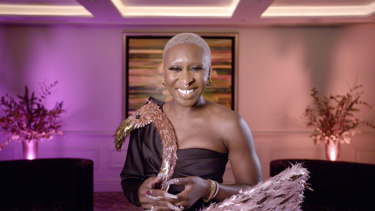 Cynthia Erivo wears a black dress with a flamingo on top of it