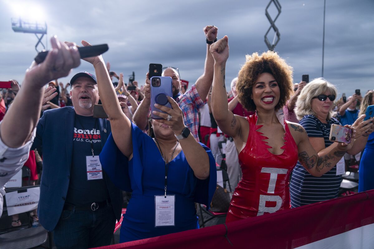 Supporters of President Donald Trump cheer as he arrives to speak at a campaign rally at Smith Reynolds Airport, Tuesday, Sept. 8, 2020, in Winston-Salem, N.C. (AP Photo/Evan Vucci)
