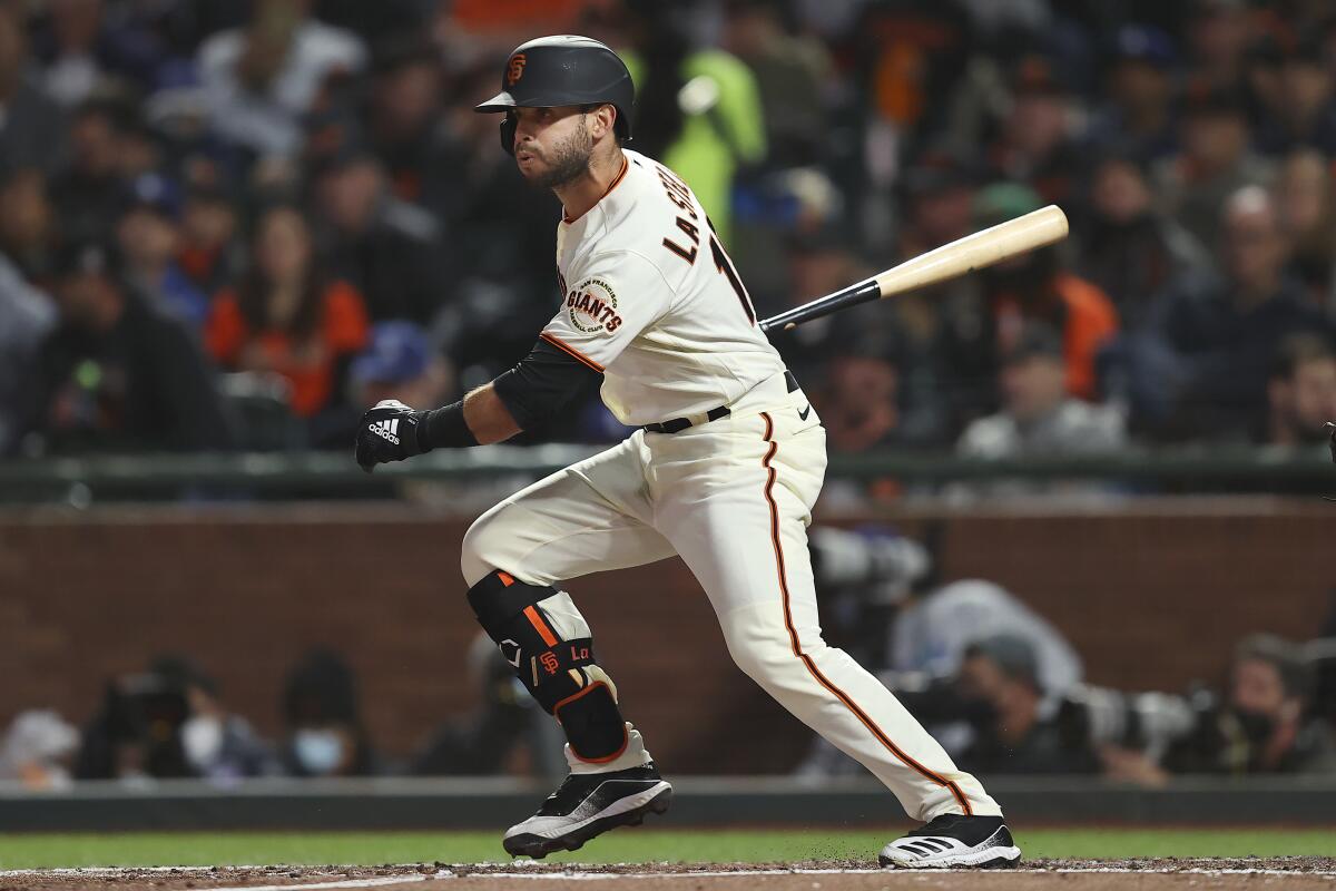 San Francisco's Tommy La Stella hits a single against the Dodgers in the third inning of Game 1 of the NLDS on Friday.