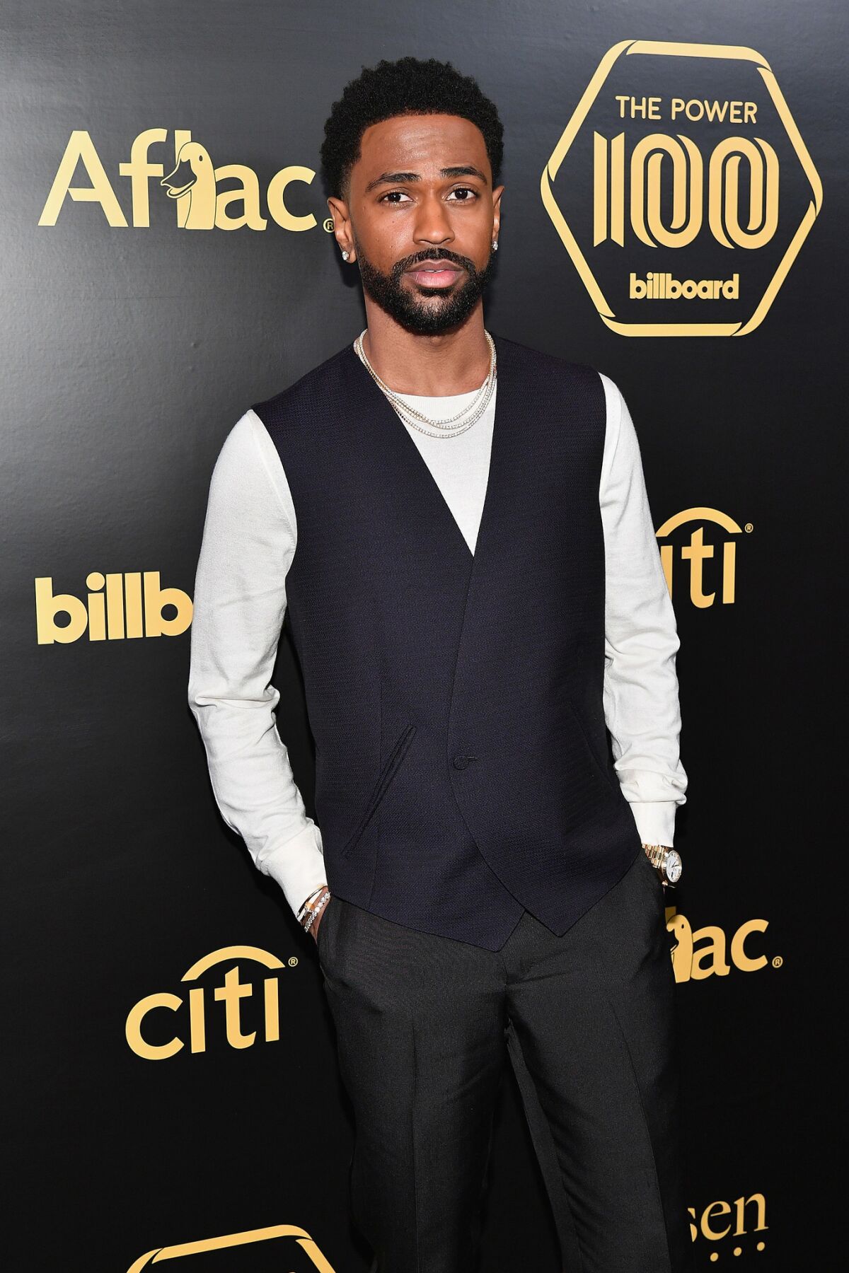 Rapper Big Sean at the Billboard Power 100 celebration in New York wearing Ermenegildo Zegna Couture mohair tuxedo trousers paired with a vest and white knit crewneck.