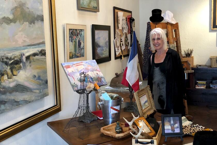 Contemporary Impressionist artist, Wendy Johnson shown in her l'atelier gallery with her recent painting of Crystal Cove, left, which will be on display during the Art in the Park show on Saturday.