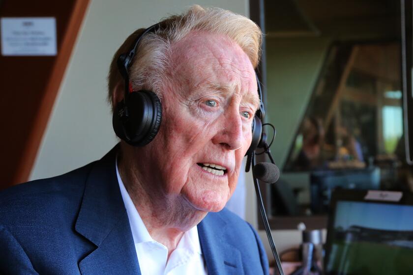 Legendary Los Angeles Dodgers broadcaster Vin Scully sits in the booth at Camelback Ranch Glendale, Ariz.