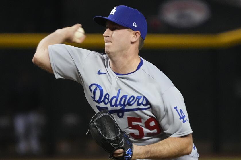 Dodgers relief pitcher Evan Phillips throws to an Arizona Diamondbacks batter in the ninth innning