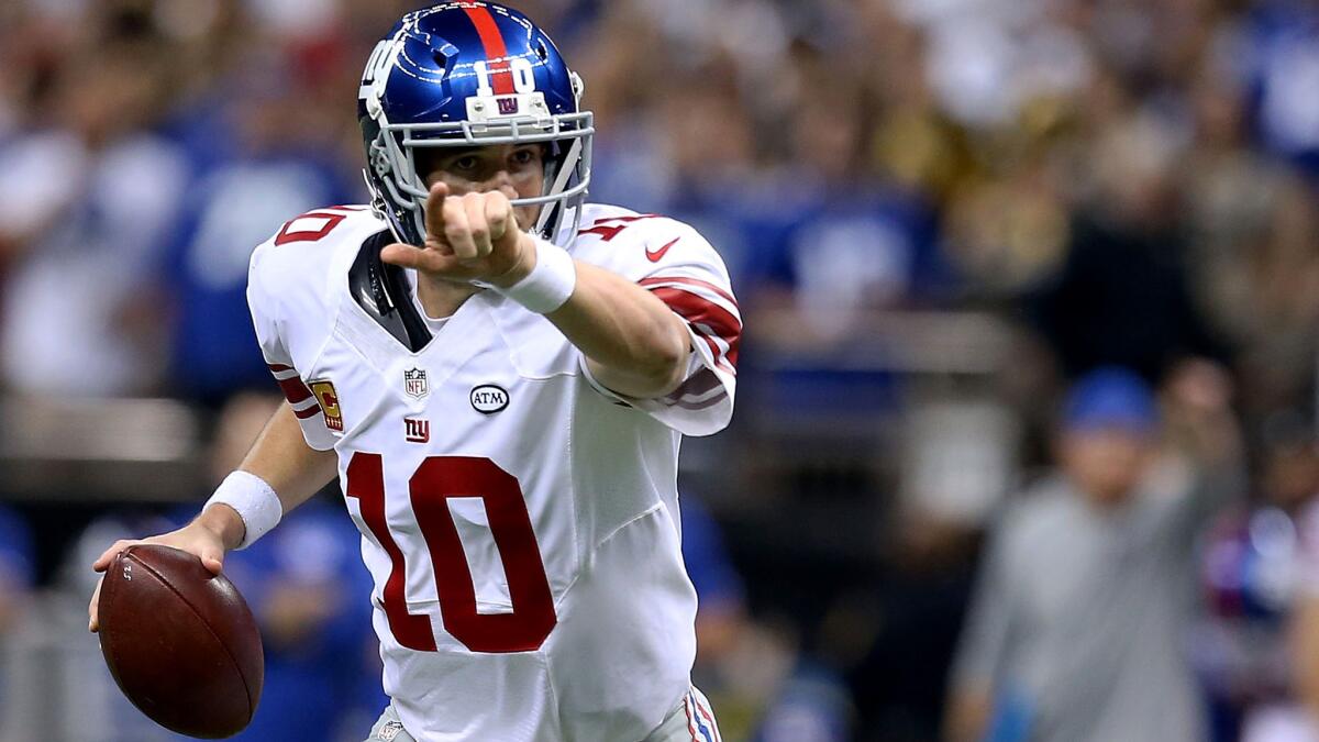 Giants quarterback Eli Manning looks to pass on a fourth-down play against the Saints on Sunday.