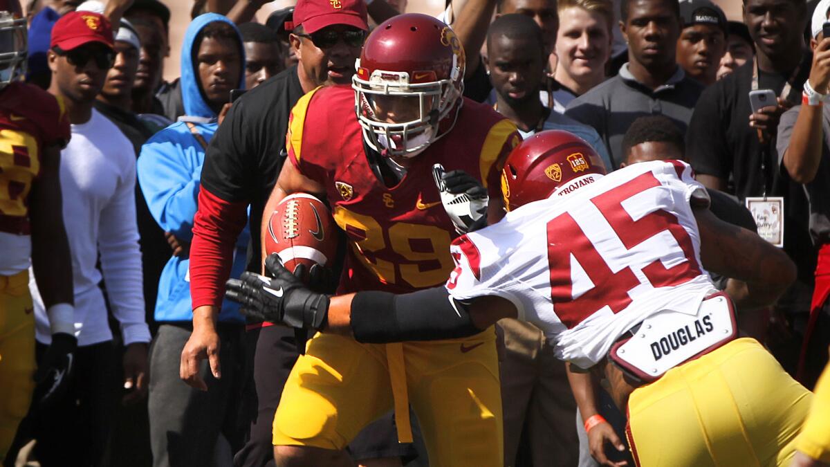 USC running back Ty Isaac, left, carries the ball during the Trojans' spring game in April. Isaac transferred to Michigan earlier this summer.