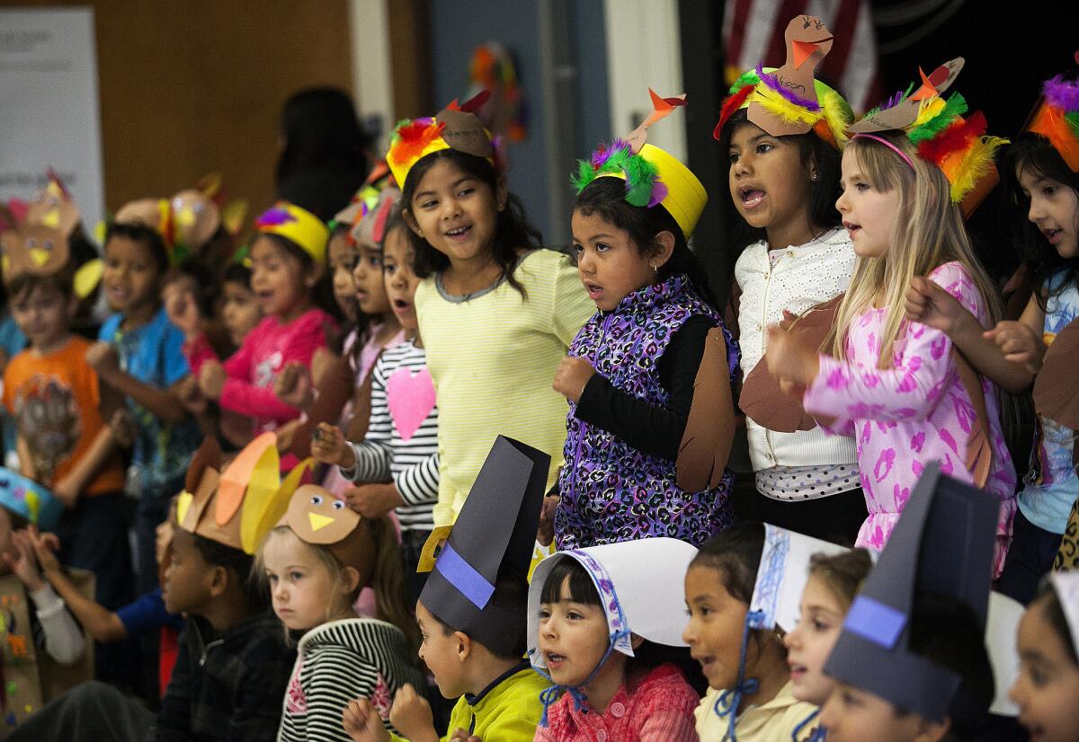 Kindergartners at Adams Elementary School sing a song during the school's annual kindergarten Thanksgiving feast on Tuesday, Nov. 26.