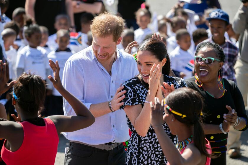Mandatory Credit: Photo by FACUNDO ARRIZABALAGA/EPA-EFE/REX (10421586i) Britain's Meghan (C), Meghan Duchess of Sussex and Prince Harry (L), Prince Harry dance during a visit to Nyanga township in Cape Town, South Africa 23 September 2019. The Duke and Meghan Duchess of Sussex are on an official visit to South Africa. The Duke and Meghan Duchess of Sussex marked their first visit in South Africa by visiting a Justice Desk initiative in Nyanga township which teaches children about their rights, self-awareness and safety, and provides self-defence classes and female empowerment training to young girls in the community. Duke and Duchess of Sussex Royal tour of South Africa, Cape Town - 23 Sep 2019 ** Usable by LA, CT and MoD ONLY **