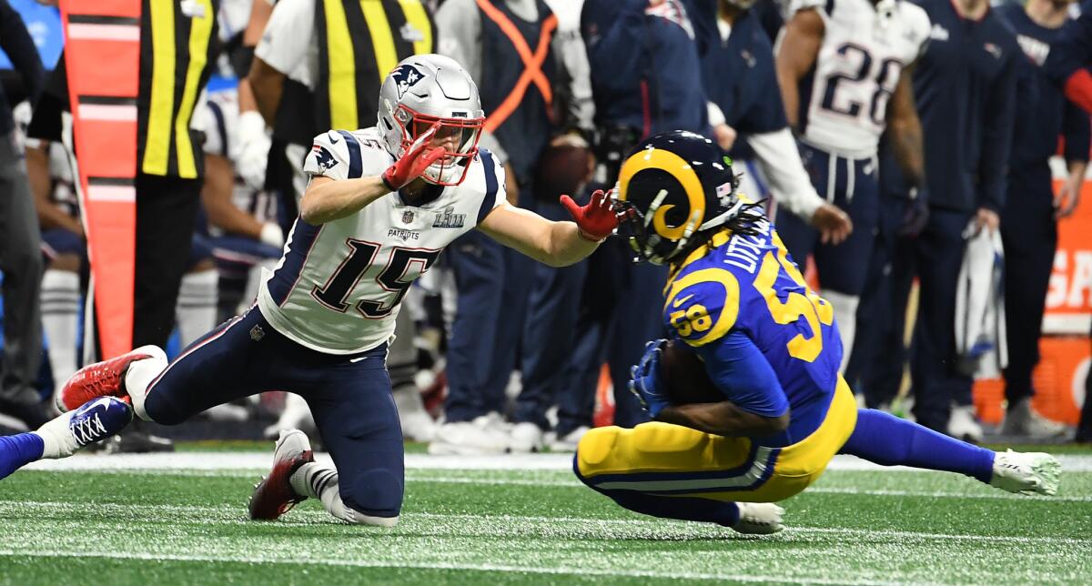 Rams linebacker Cory Littleton intercepts a pass intended for Patriots receiver Chris Hogan in the first quarter.