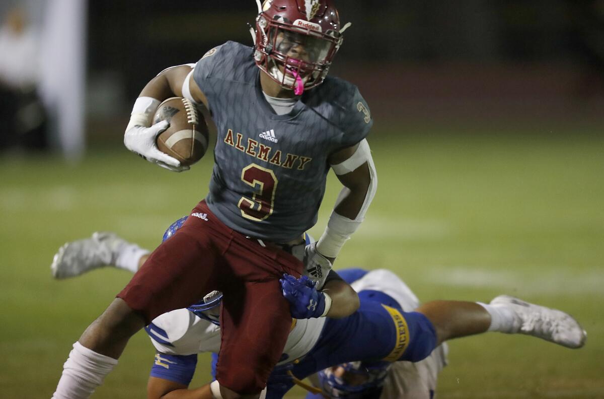 Alemany running back Floyd Chalk sheds an Bishop Amat defender during Friday's game.