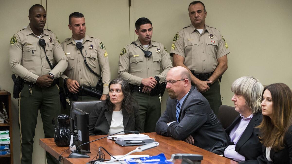 Louise Turpin, left, and David Turpin, second from right, pleaded not guilty to multiple counts of torture, child abuse, abuse of dependent adults and false imprisonment Thursday in Riverside County Superior Court.
