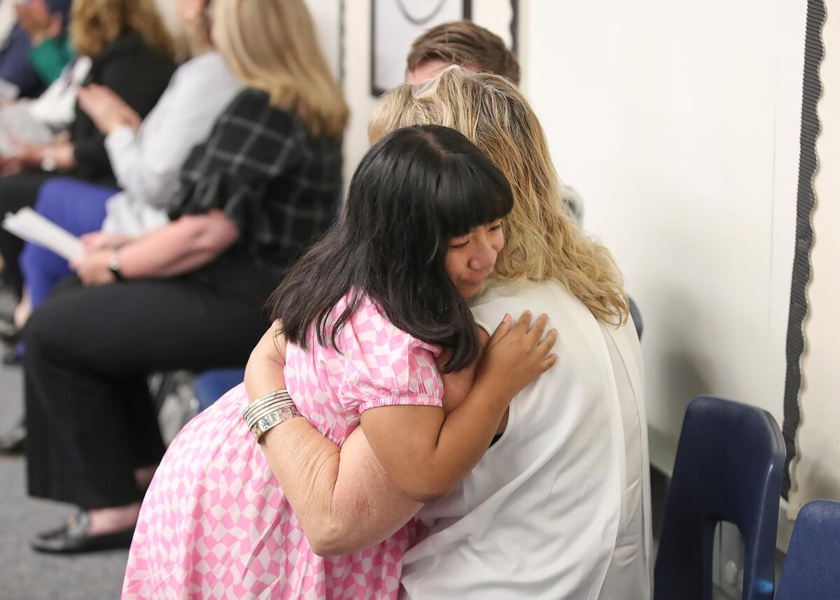 Lauren Tran shares a hug after graduating from Newport-Mesa Unified's STEP program at the Harper Assessment Center Wednesday.