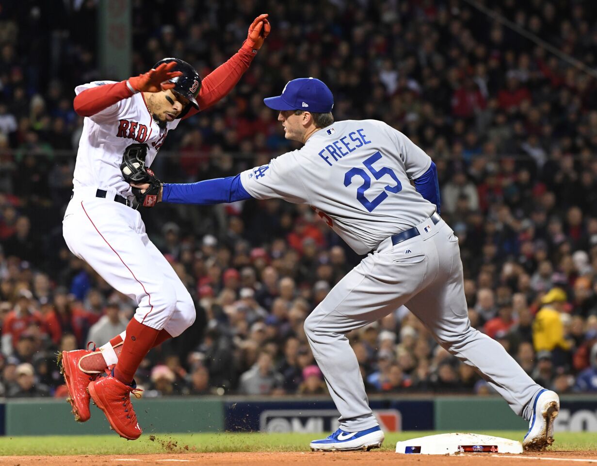 Dodgers first baseman David Freese tags out Red Sox Mookie Betts in the first inning.