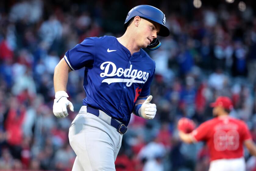 ANAHEIM, CALIFORNIA - MARCH 26: Dodgers Will Smith trots around the bases after hitting a solo home run in the fourth inning at Angels Stadium Tuesday. (Wally Skalij/Los Angeles Times)