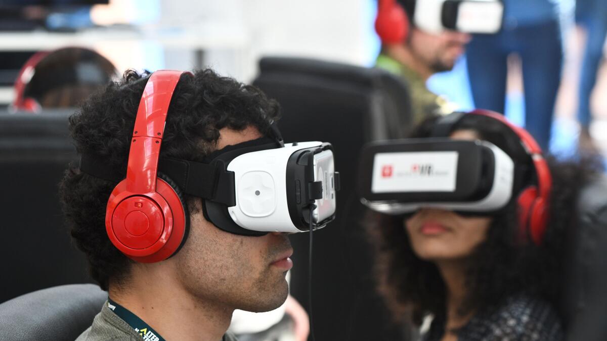 People test out Samsung's Gear VR powered by Oculus during Sunny Side of the Doc, an international market for documentary films, in La Rochelle, France, on June 21, 2016.