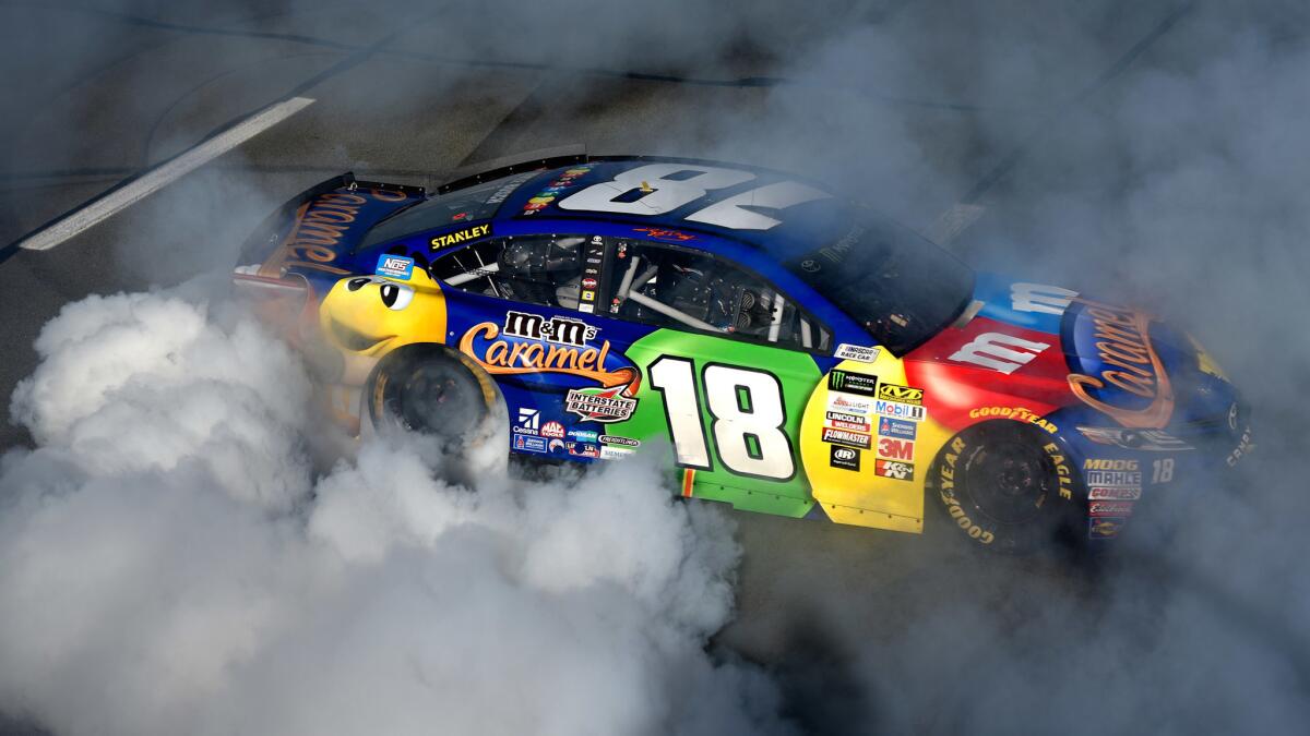 NASCAR driver Kyle Busch does a burnout after winning the Overton's 400 at Pocono Raceway on Sunday.