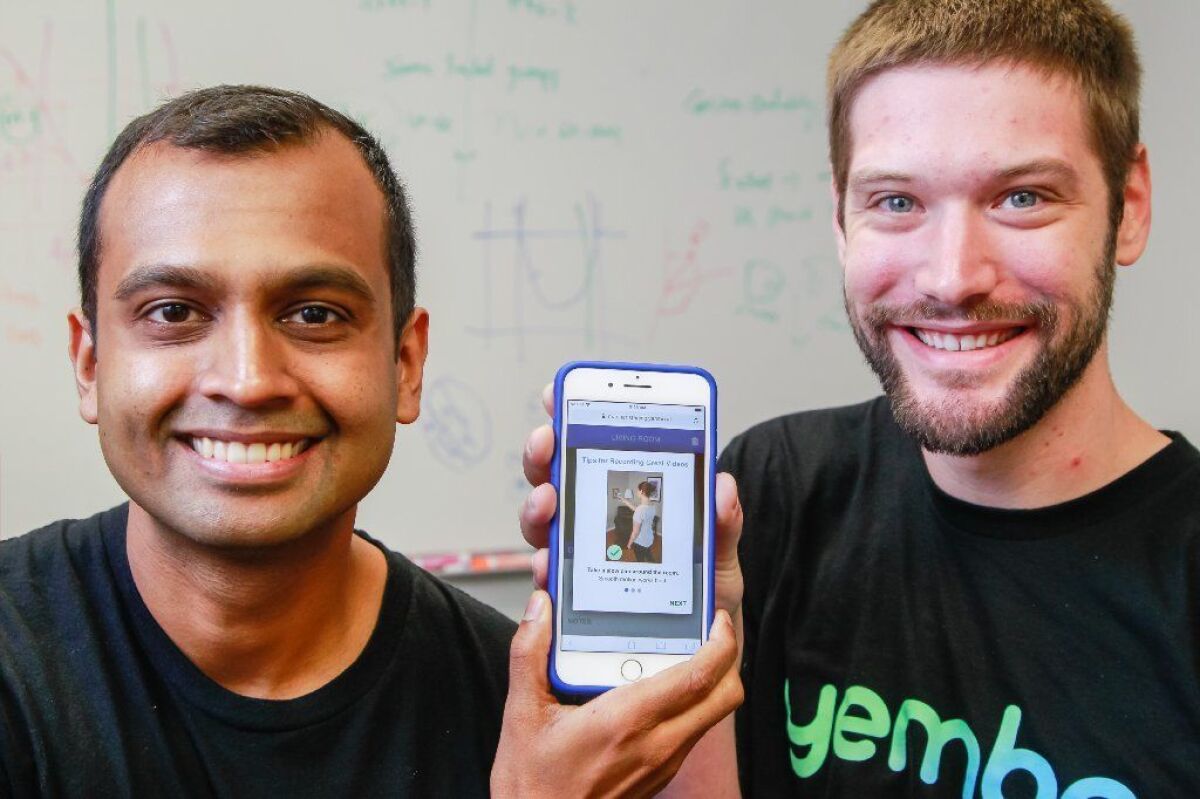 Yembo co-founders Siddhartha Mohan (left) and Zach Rattner pose at their office in 2018.