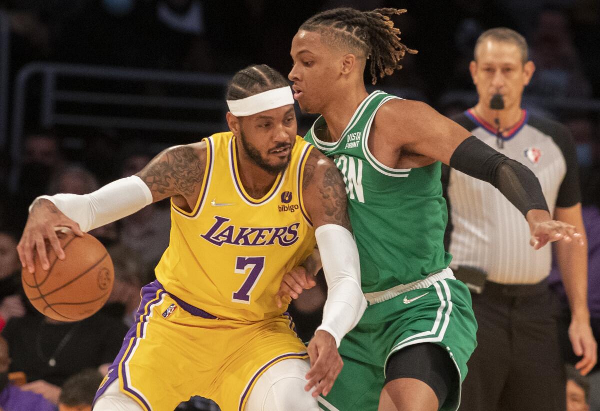 Lakers forward Carmelo Anthony drives against Celtics guard Romeo Langford.