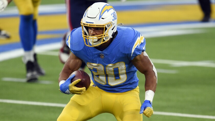Chargers running back Austin Ekeler carries the ball against the New England Patriots.