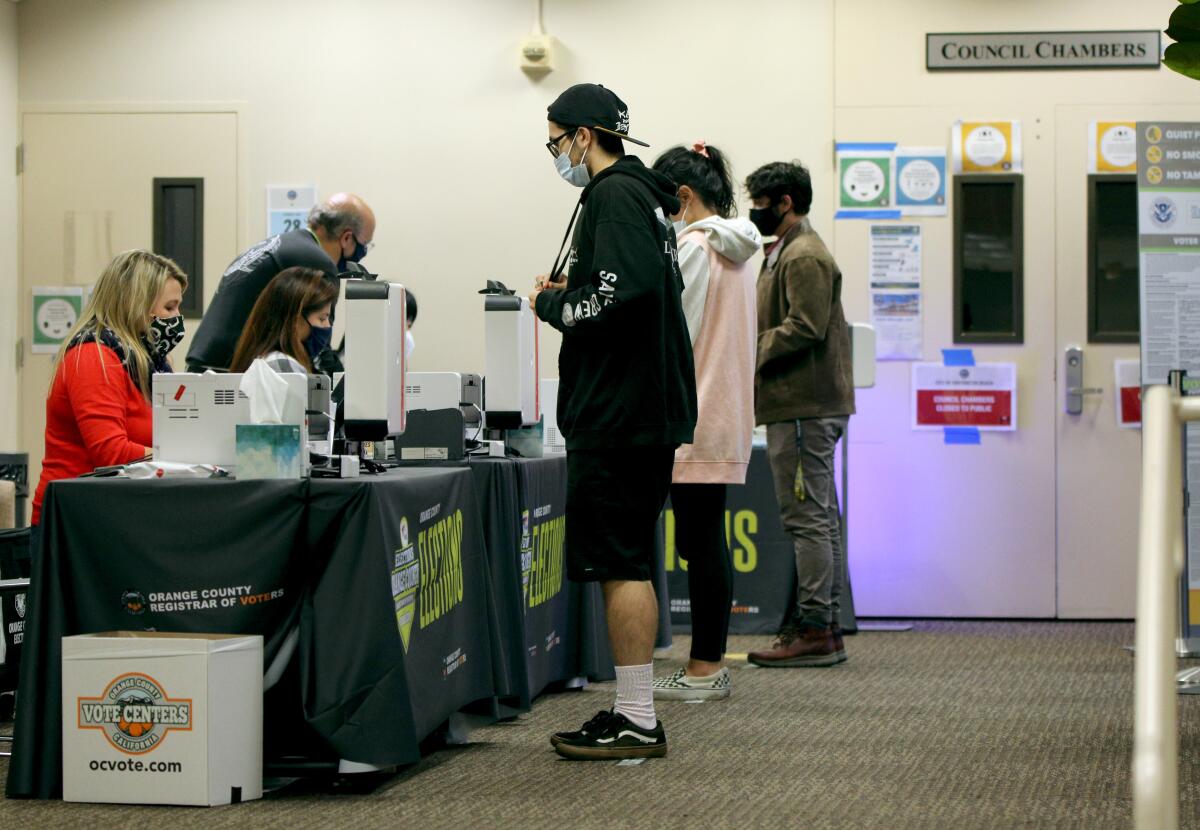 Voters check in at the Civic Center polling location in Huntington Beach in 2020.