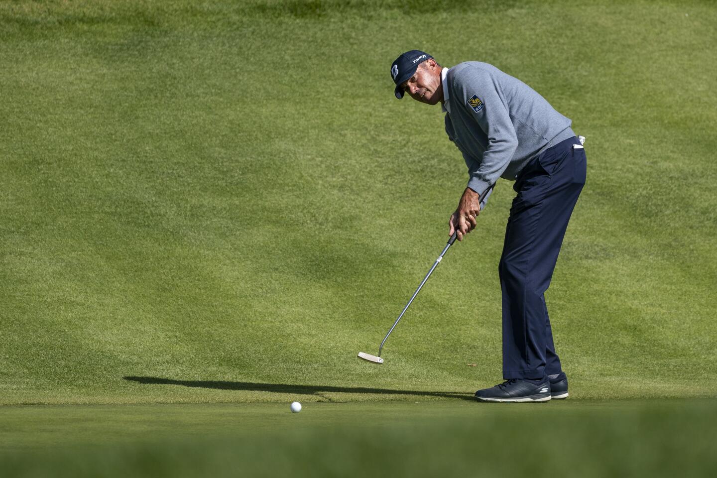 Matt Kuchar sinks a putt for par on the second green during the first round of the Genesis Invitational at Riviera Country Club on Feb. 13, 2020.